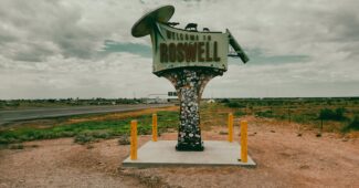 welcome signage under white clouds