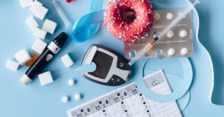 blood sugar meter and medication on the blue background