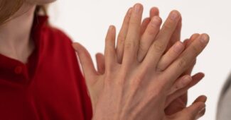 man squeezing partner hands