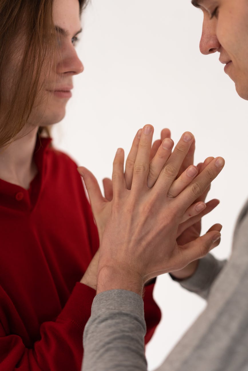 man squeezing partner hands